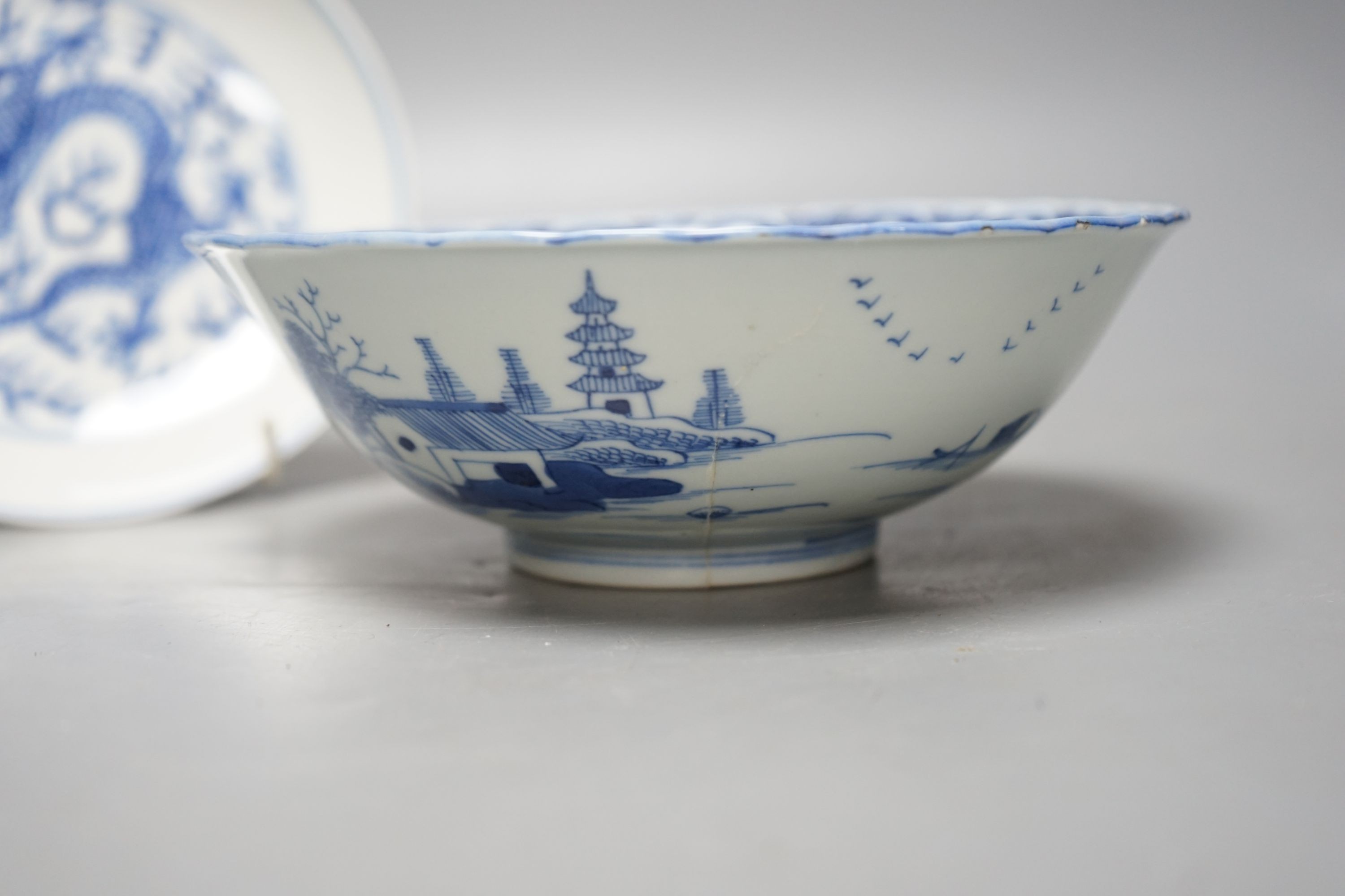 A Chinese blue and white landscape bowl, a/f and a Chinese blue and white 'dragon' dish, 18cm and 16.5cm